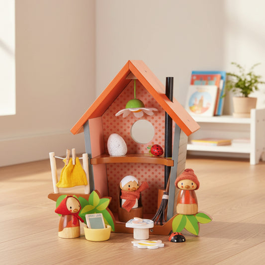 Wooden fairy house with miniature accessories on a white background