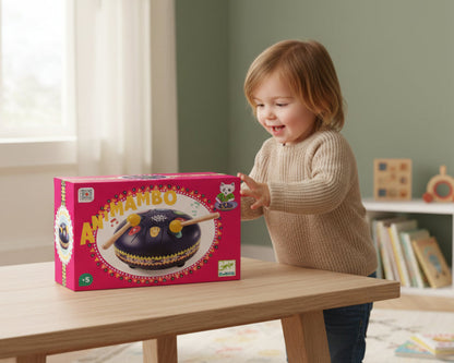 Toy drum set with two mallets on a pink box featuring 'Antimambo' and Djeco branding.