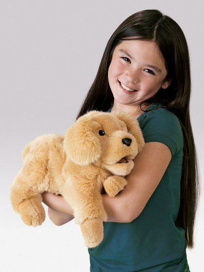 Young girl holding a plush dog toy against a plain background