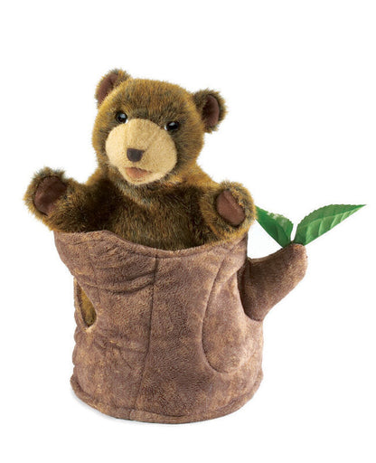 puppet Stuffed bear in a brown pouch with a green leaf on a white background