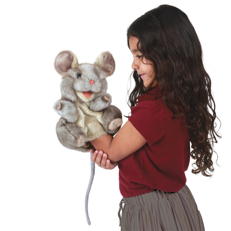 Child holding a plush mouse toy against a white background