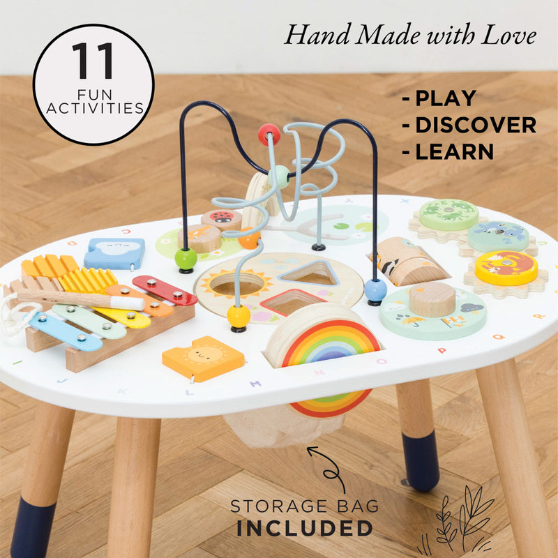 Children's activity table with various educational toys on a wooden floor.