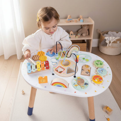 Child playing with a colorful toy table on a light gray background