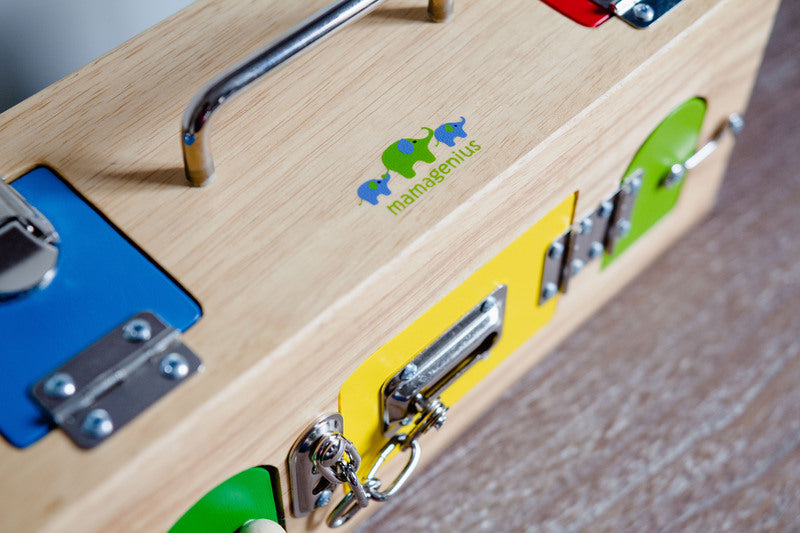 Wooden toolbox with colorful tool compartments and a brand logo on a wooden surface.