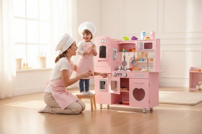 Pink children's play kitchen set with various appliances on a white background