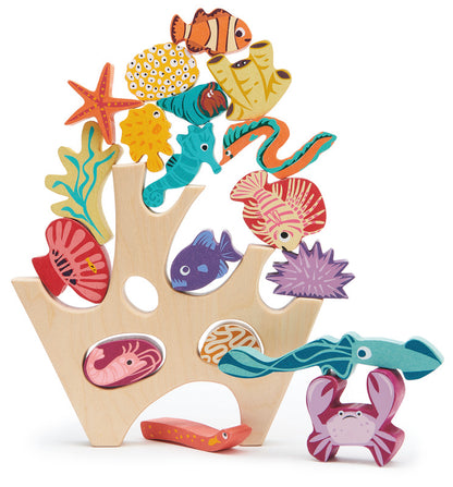 Colorful wooden sea creature toys on a coral-like base with a white background