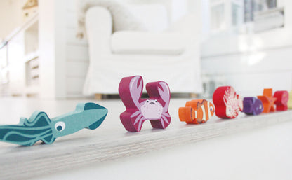 Colorful toy fish on a white surface with a blurred indoor background