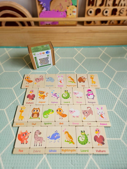Set of animal-themed wooden blocks on a green tiled surface with a small box in the background.