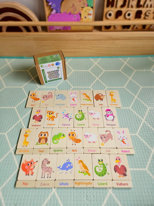 Set of animal-themed wooden blocks on a green tiled surface with a small box in the background.