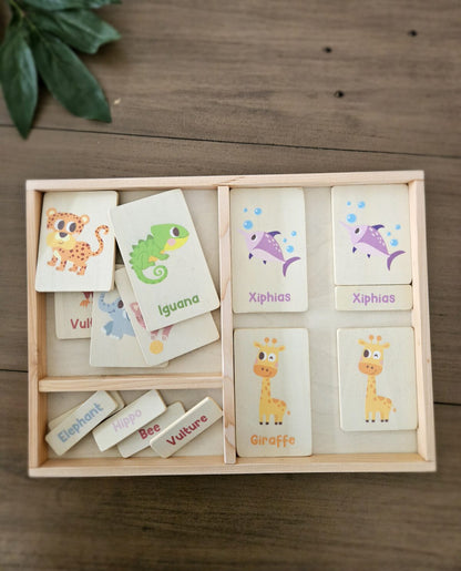Wooden educational toy with animal cards and labels on a wooden surface