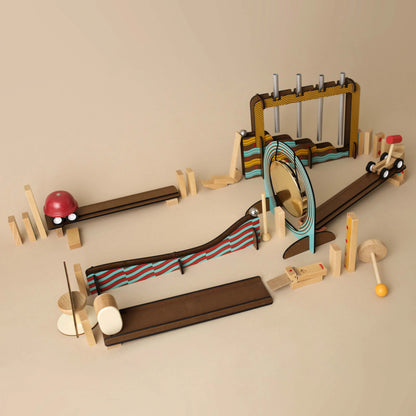Wooden toy track set with various obstacles on a beige background